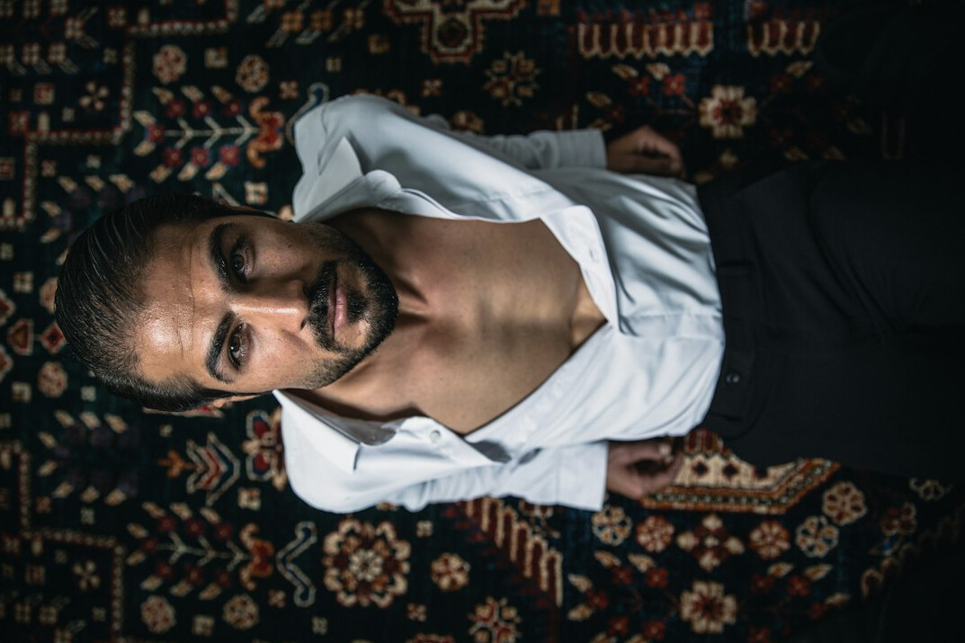 Studio portrait of a Turkish man editor-in-chief in a shirt