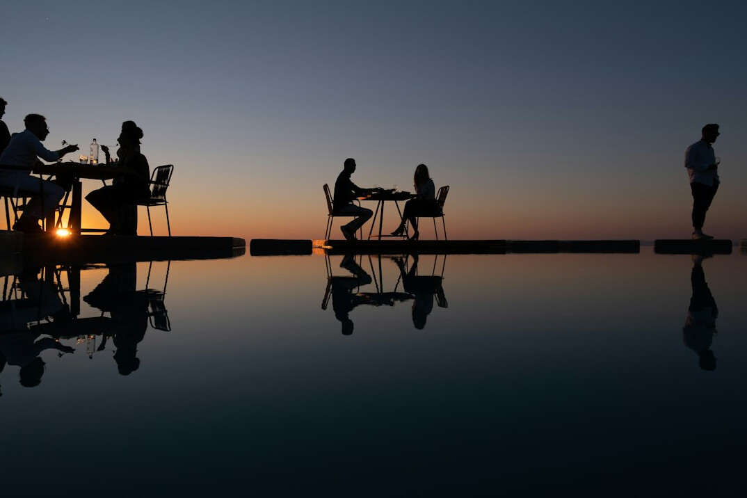 Editorial team having a meeting around a table with laptops